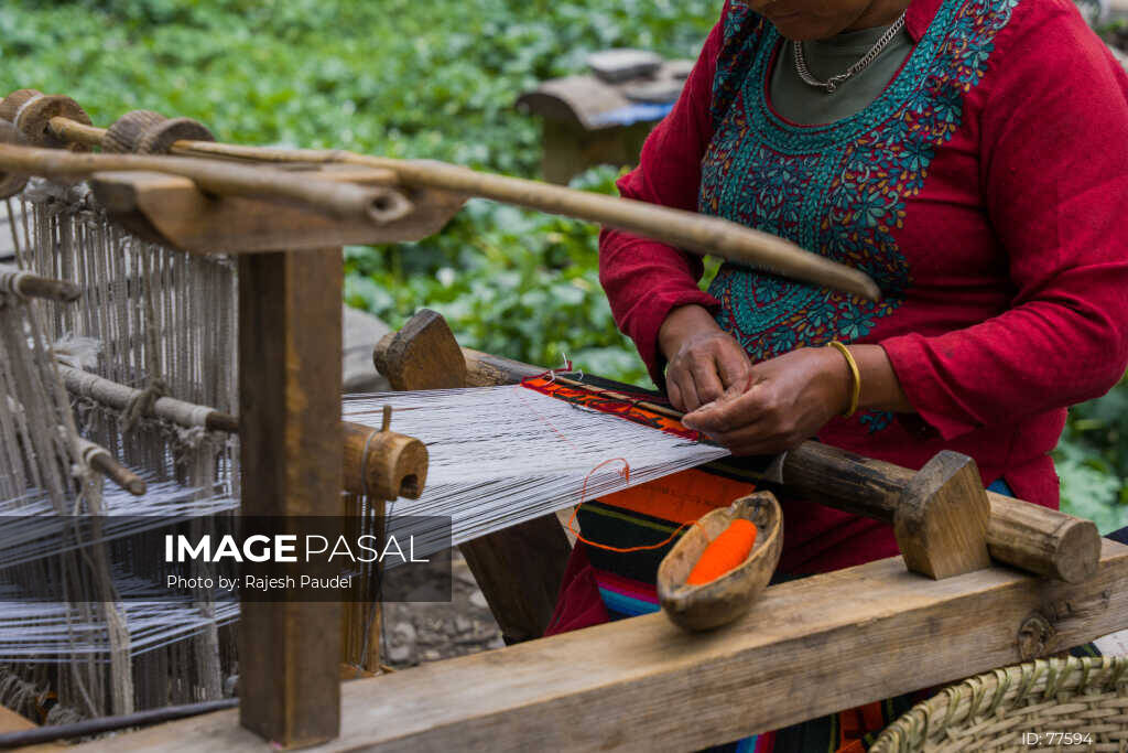 Woman weaving on a traditional wooden loom in Nepal