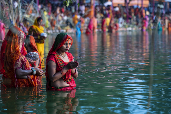 worshipping rising sun on Chhath puja at Ganga Sagar pond