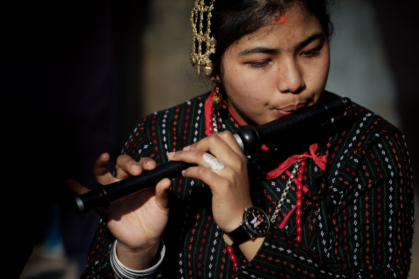 Nepalese girl playing flute