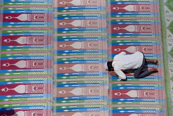 A Muslim man offers prayers