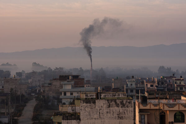 Industrial chimneys releasing black smoke