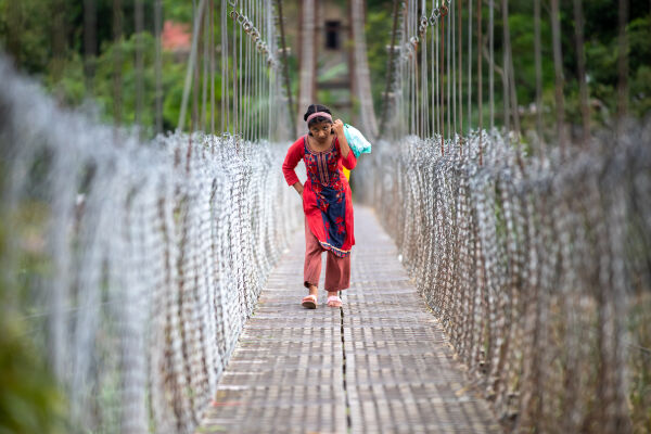 A kid walking in the bridge.