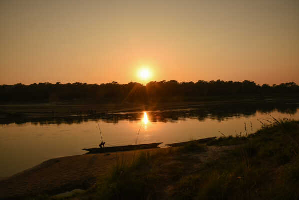 Sunset over Rapti River & boats, Sauraha, Chitwan