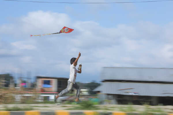 Child flying a kite during the Dashain festival in Nepal