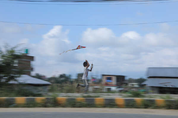 Child flying a kite during the Dashain festival in Nepal