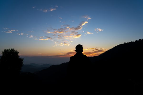 Silhouette of man and Sunrise in the clouds