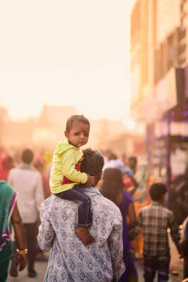 Child on Shoulders in a Festive Crowd
